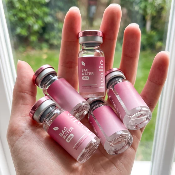 Healio Peptides vials beside bacteriostatic water