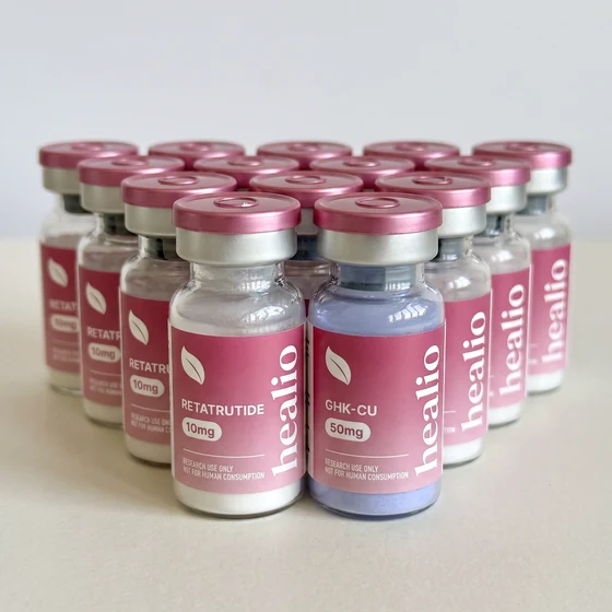 A row of Healio Peptides vials in soft daylight