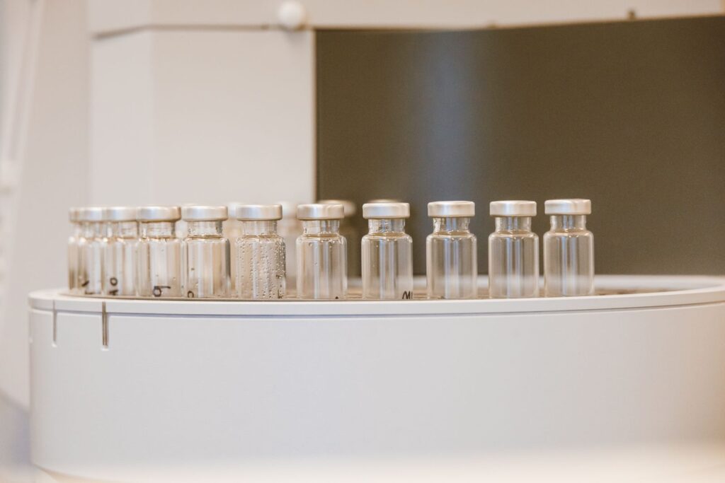 Empty glass vials arranged in a rack on a laboratory bench