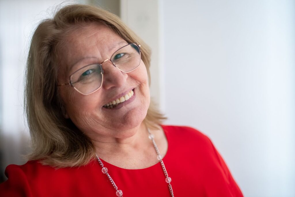 Older woman smiling in warm indoor light