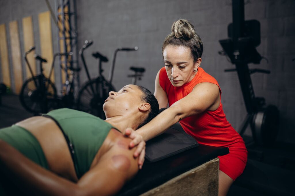 Therapist working on a woman's shoulder during a manual mobility session