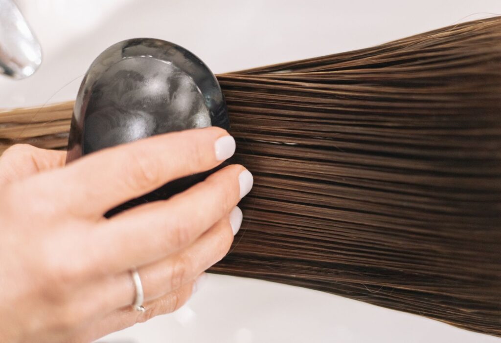 Close view of a woman brushing long brown hair
