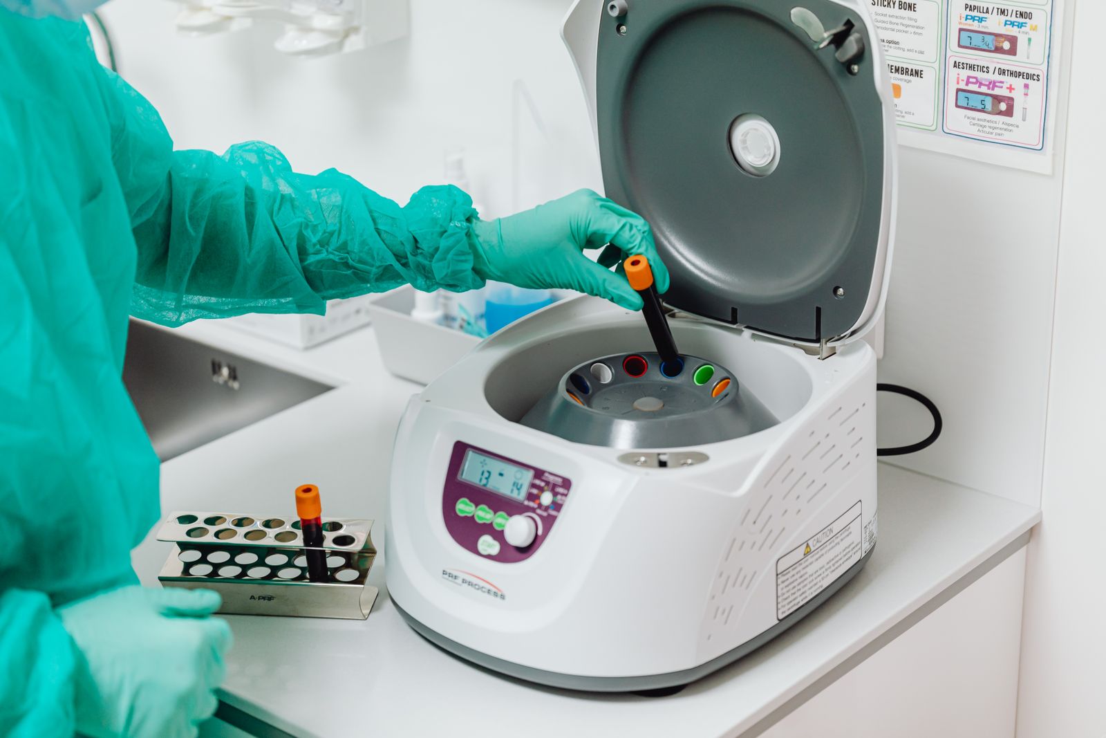 A laboratory professional operating a centrifuge