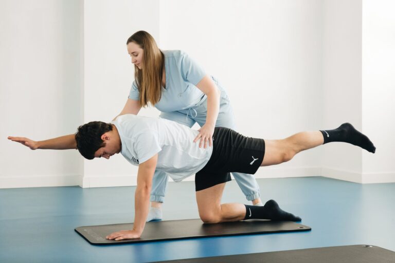 A physiotherapist guiding a patient through exercises in a clinic