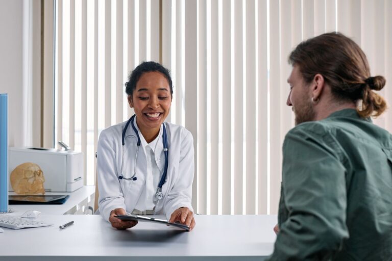 A clinician and patient talking during a consultation