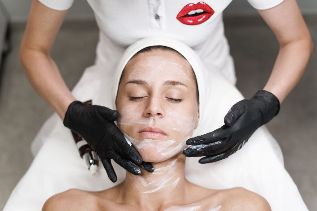 A woman receiving a facial treatment in a calm clinic setting