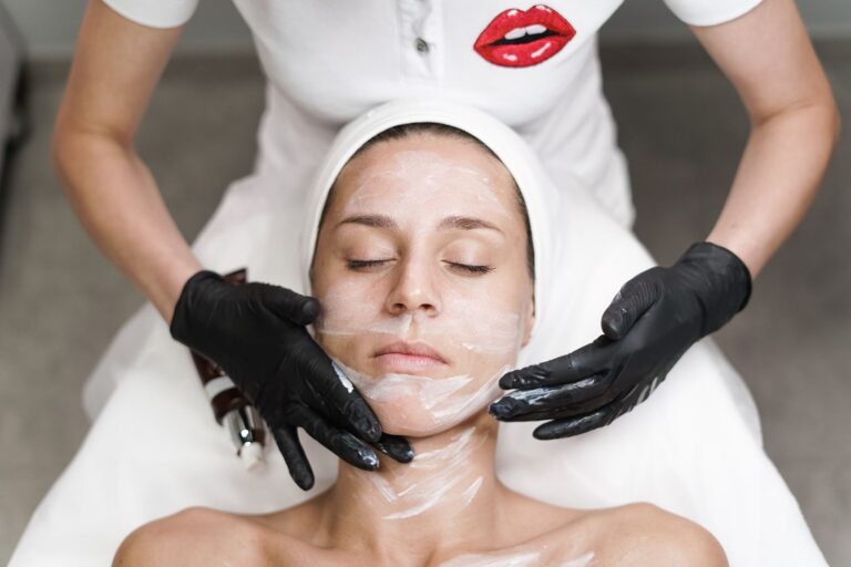 A woman receiving a facial treatment in a calm clinic setting