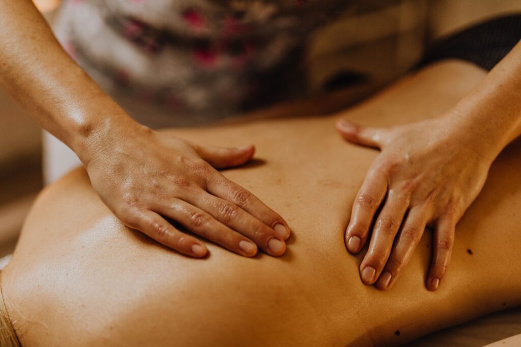 Hands giving a back massage in a quiet room