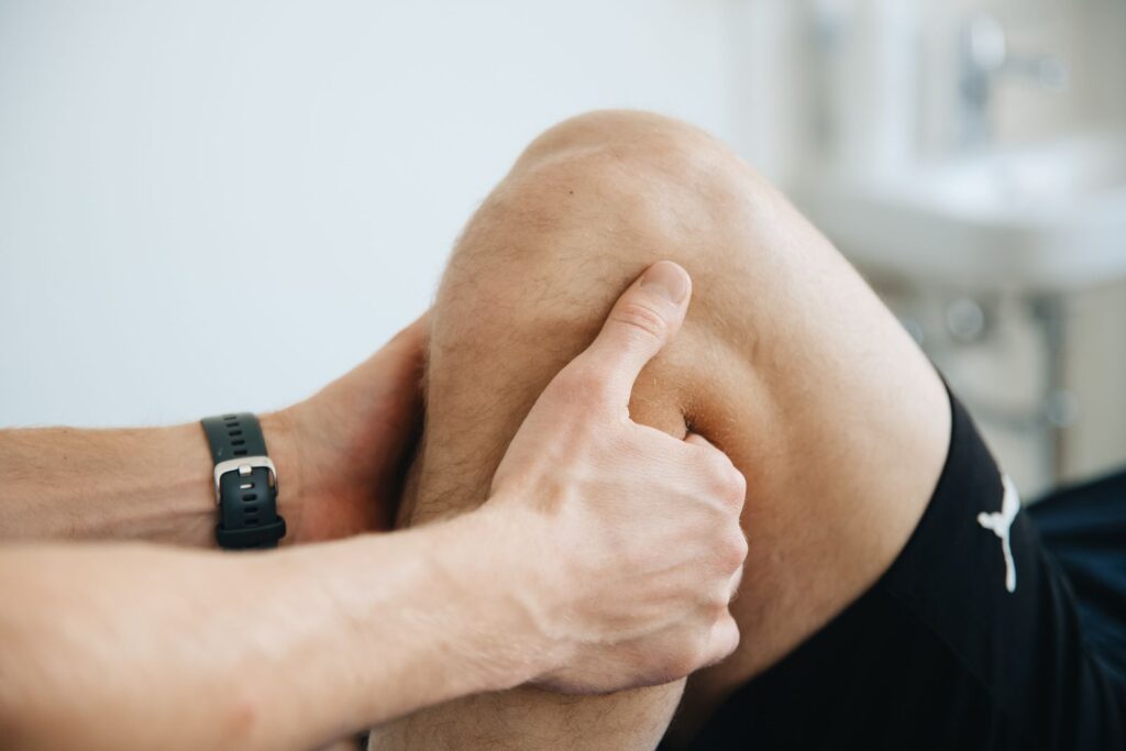A physiotherapist working on a knee during therapy
