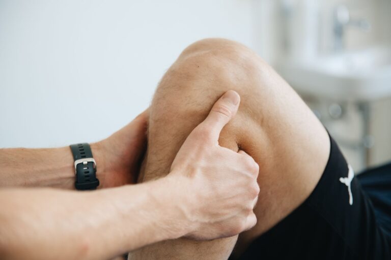 A physiotherapist working on a knee during therapy