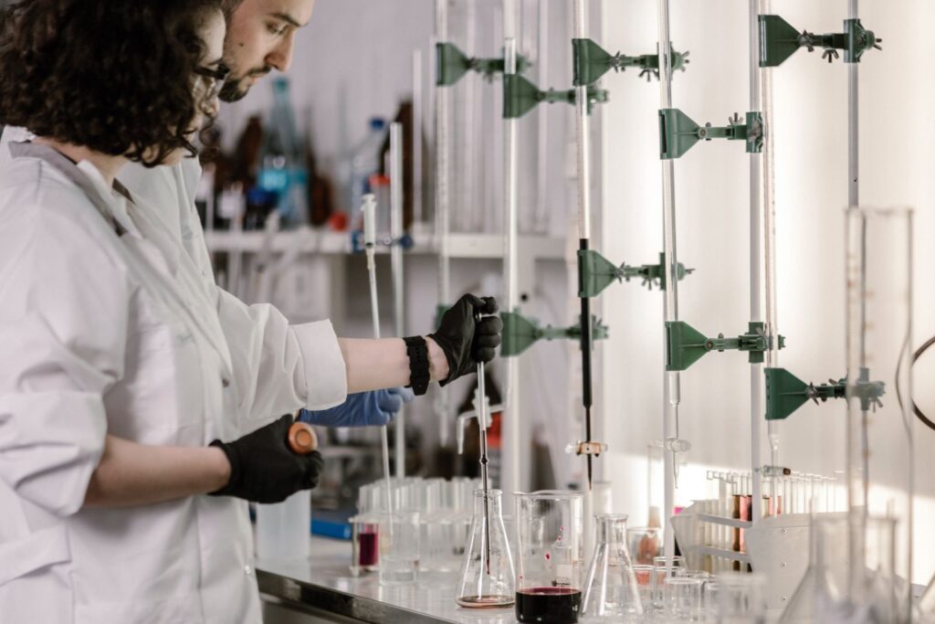 Scientists in lab coats working with test tubes in a modern laboratory