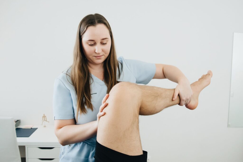 A physiotherapist assisting with a leg therapy session