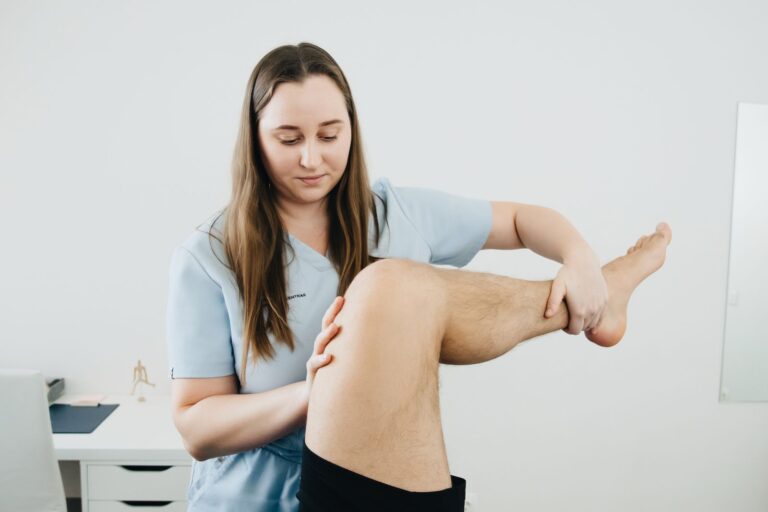 A physiotherapist assisting with a leg therapy session