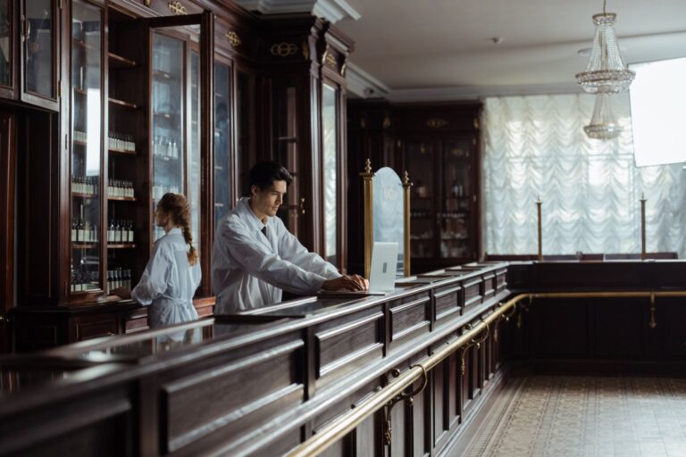 A traditional pharmacy interior with staff at the counter