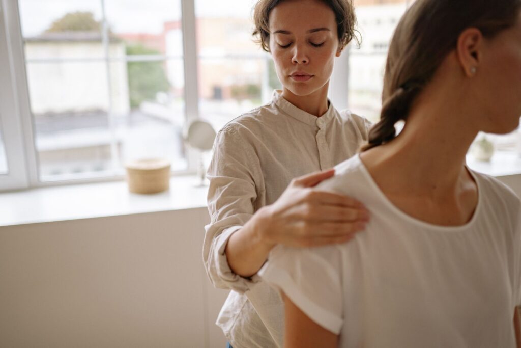 A physiotherapist treating a client in a bright modern clinic