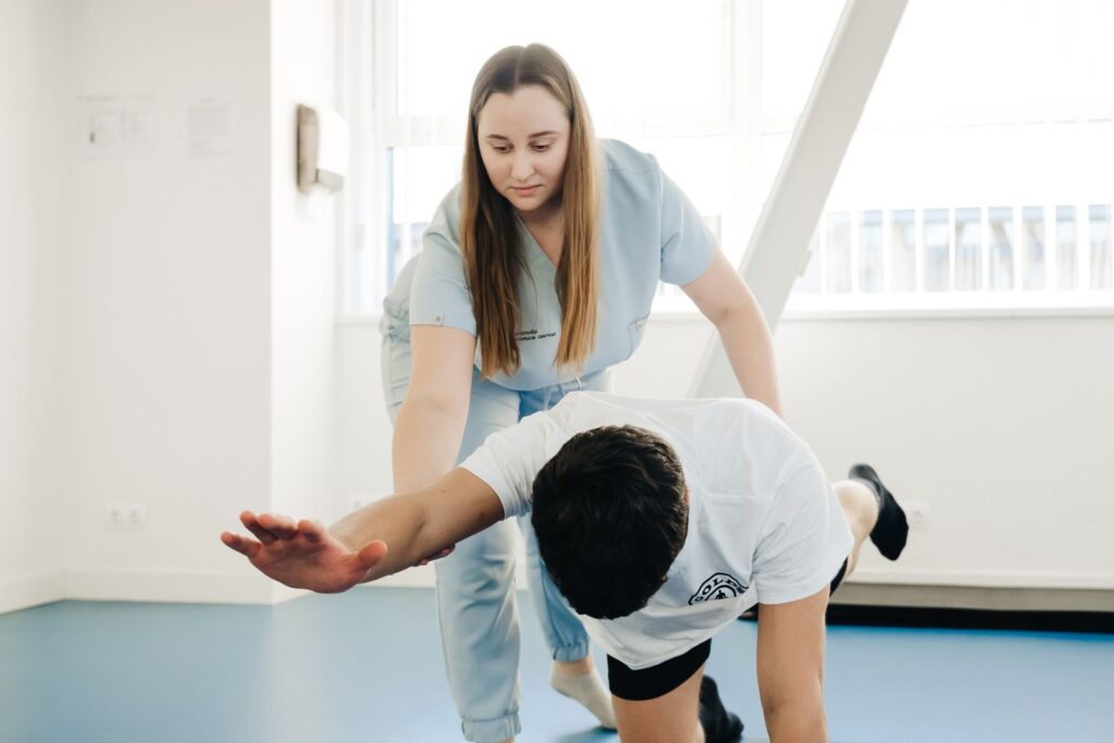 A physiotherapist guiding a patient through a stretch