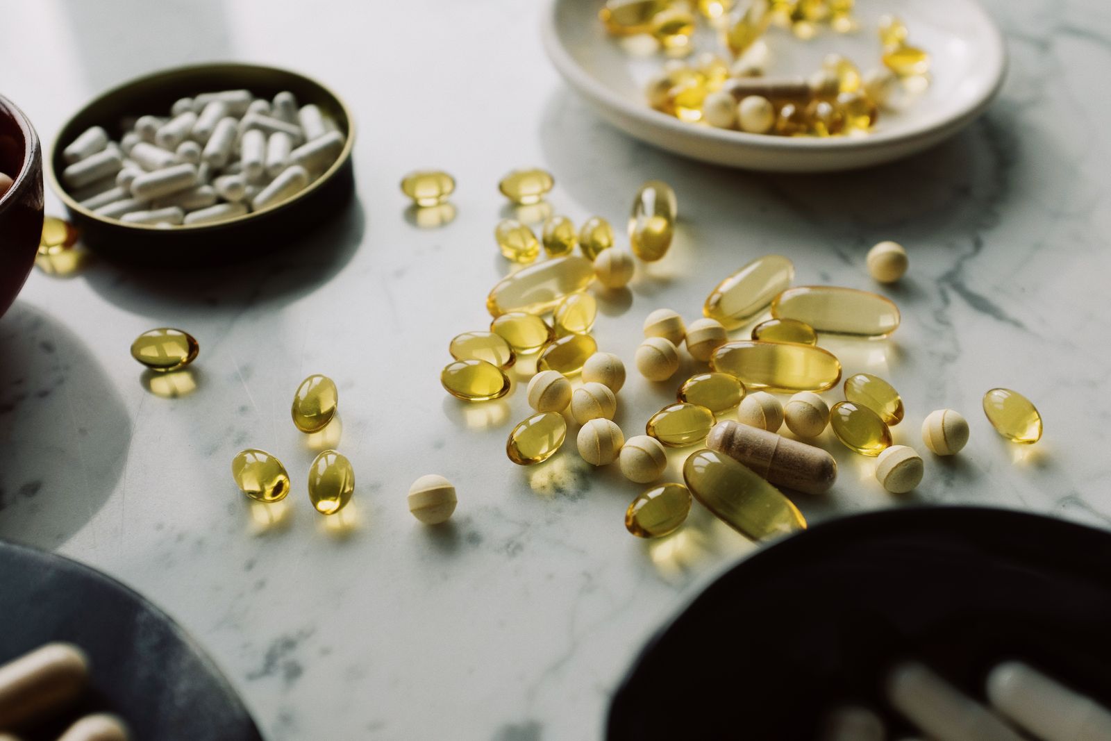 Assorted capsules arranged on a marble surface
