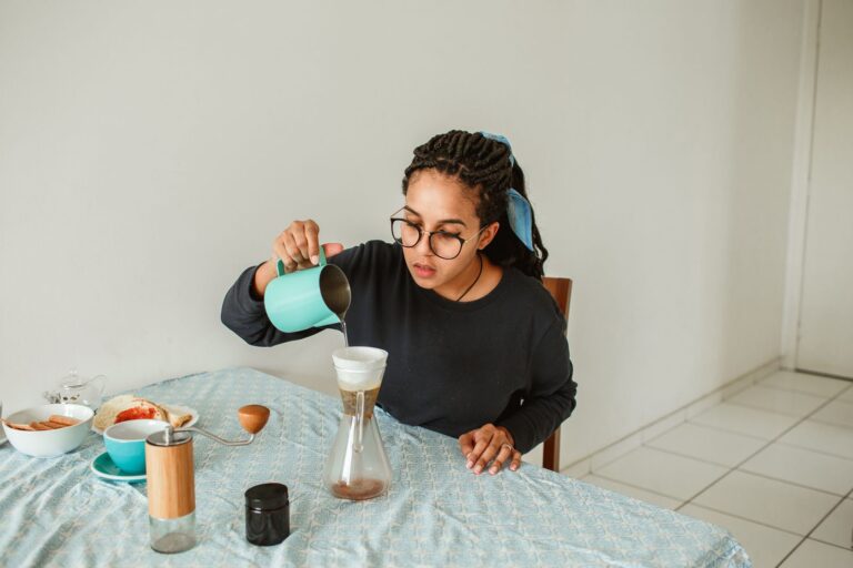 A woman pouring coffee in a calm home setting