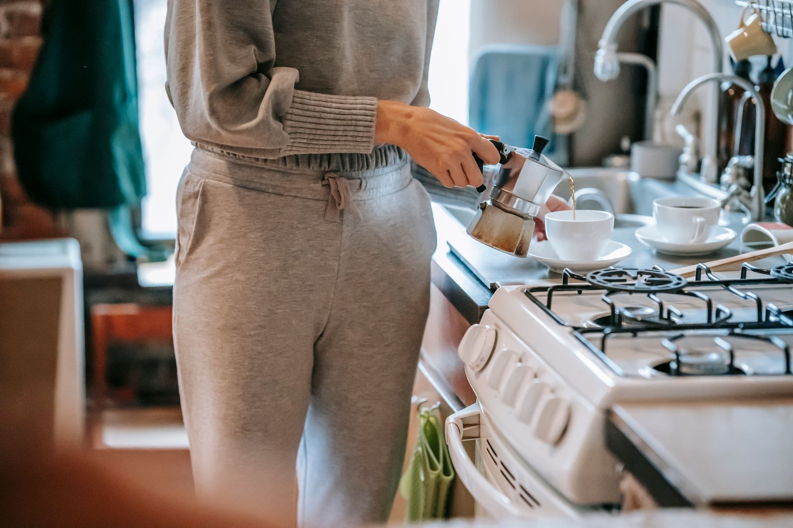 A woman pouring freshly brewed coffee