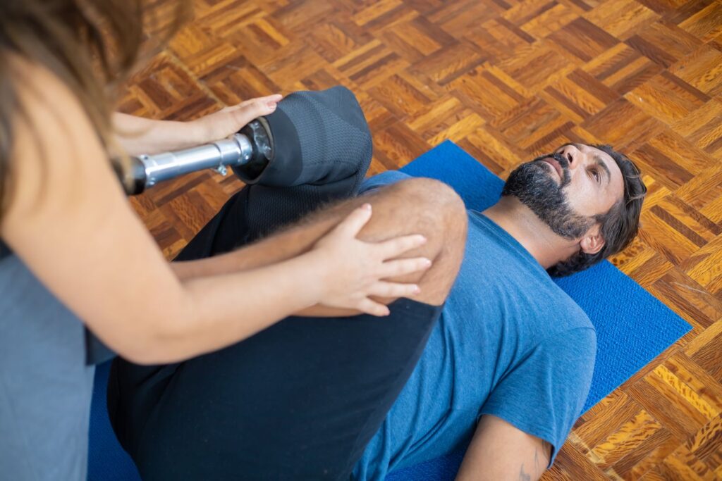 A person receiving guided rehabilitation therapy indoors