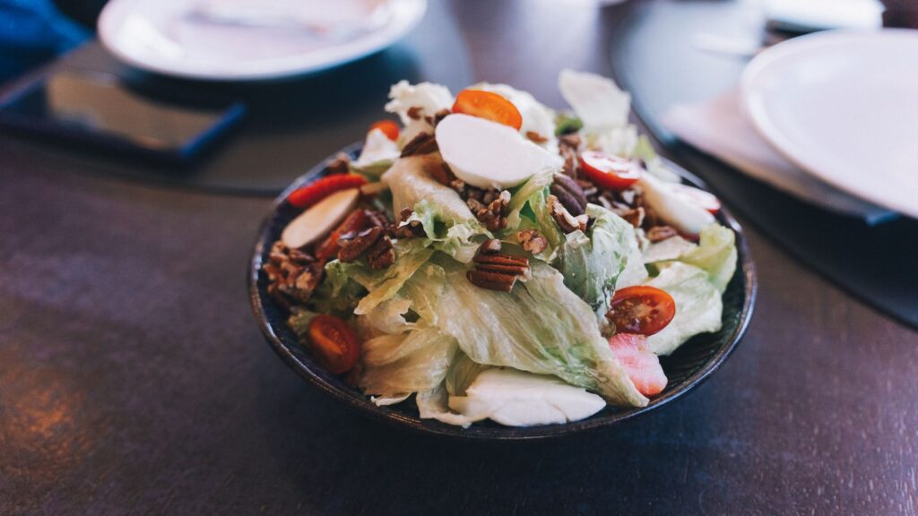 A fresh salad with cherry tomatoes and nuts in a bowl