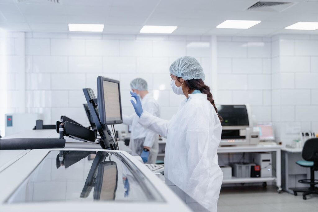 A scientist in protective gear operating equipment in a modern laboratory