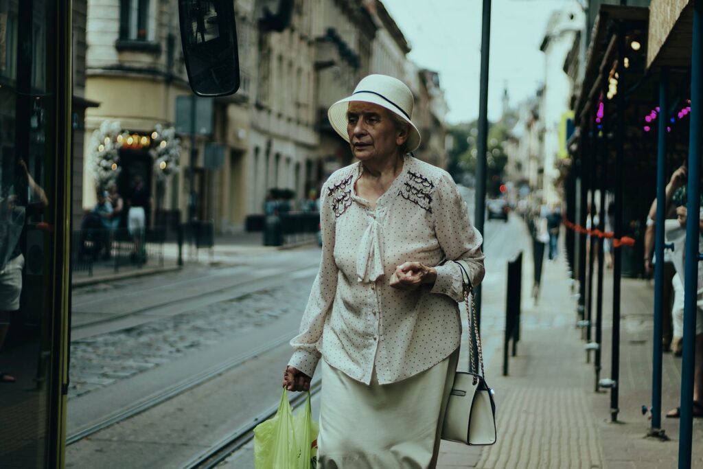 An older woman walking along a city street