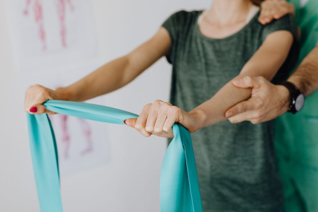 A clinician supporting a shoulder during an assessment