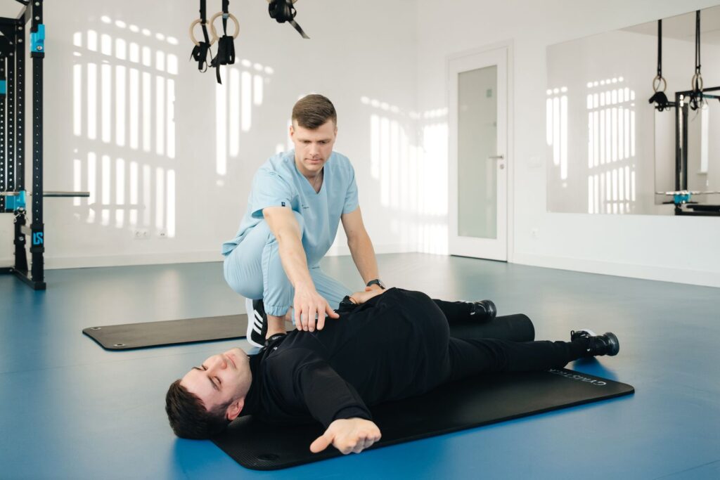 A physiotherapist assisting a patient with stretching exercises