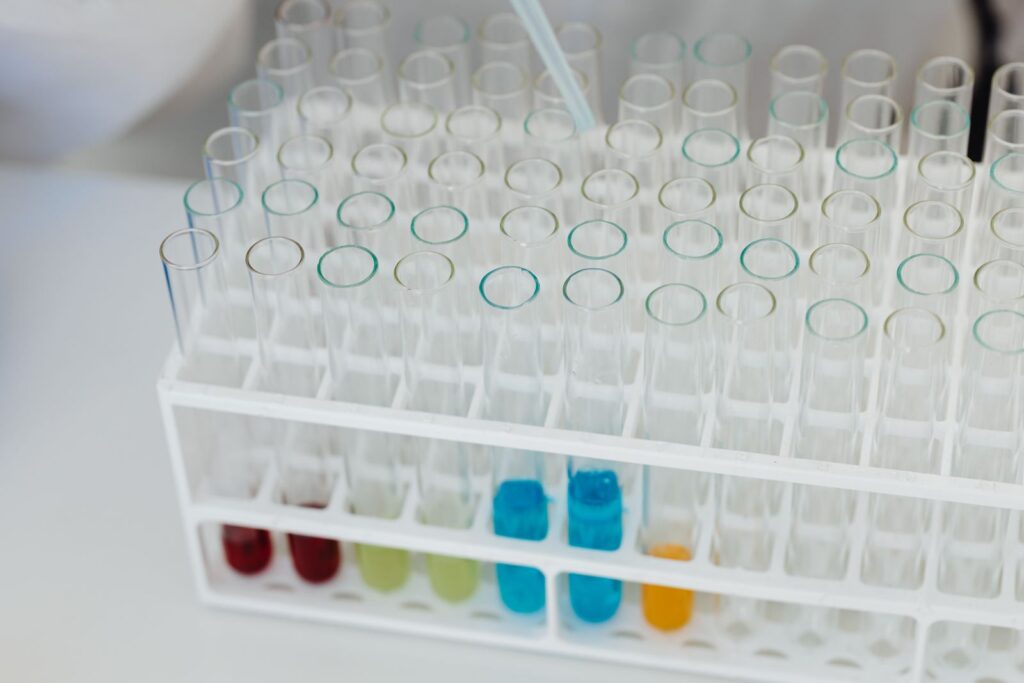 A test tube rack holding coloured chemical solutions