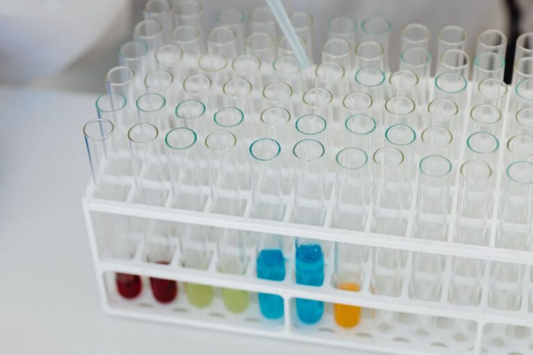 A test tube rack holding coloured chemical solutions