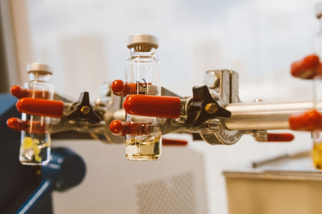 Laboratory vials held in a clamp during handling