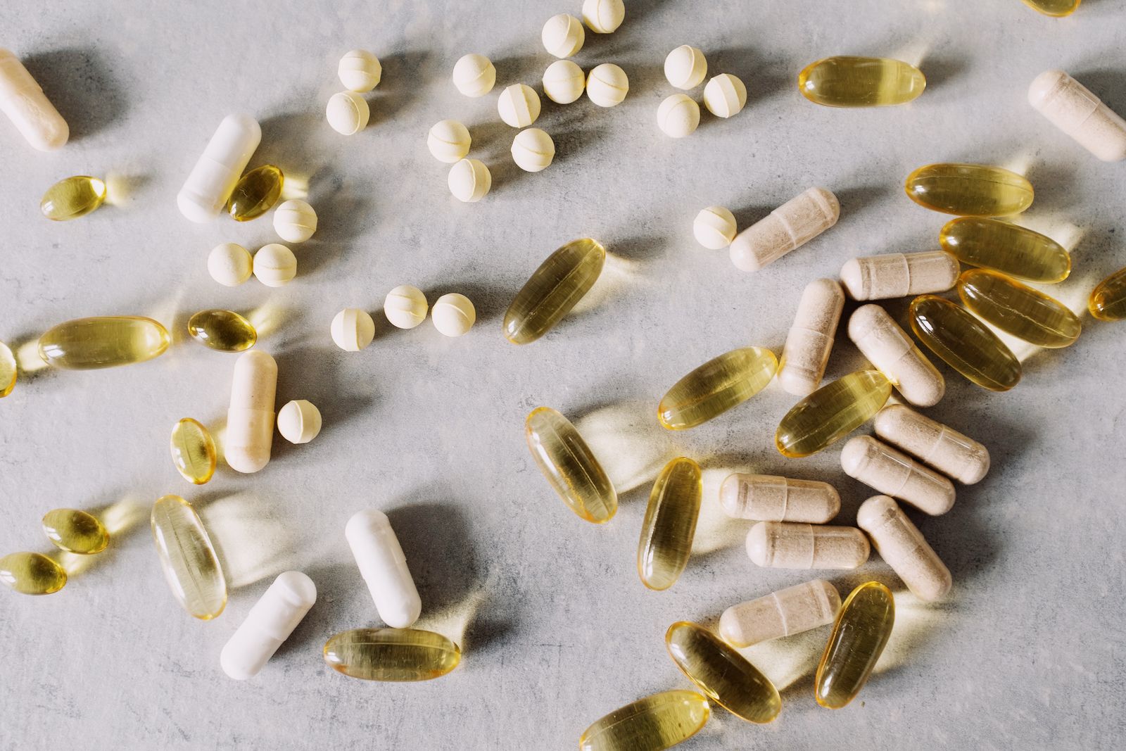 Capsules and tablets arranged on a marble background