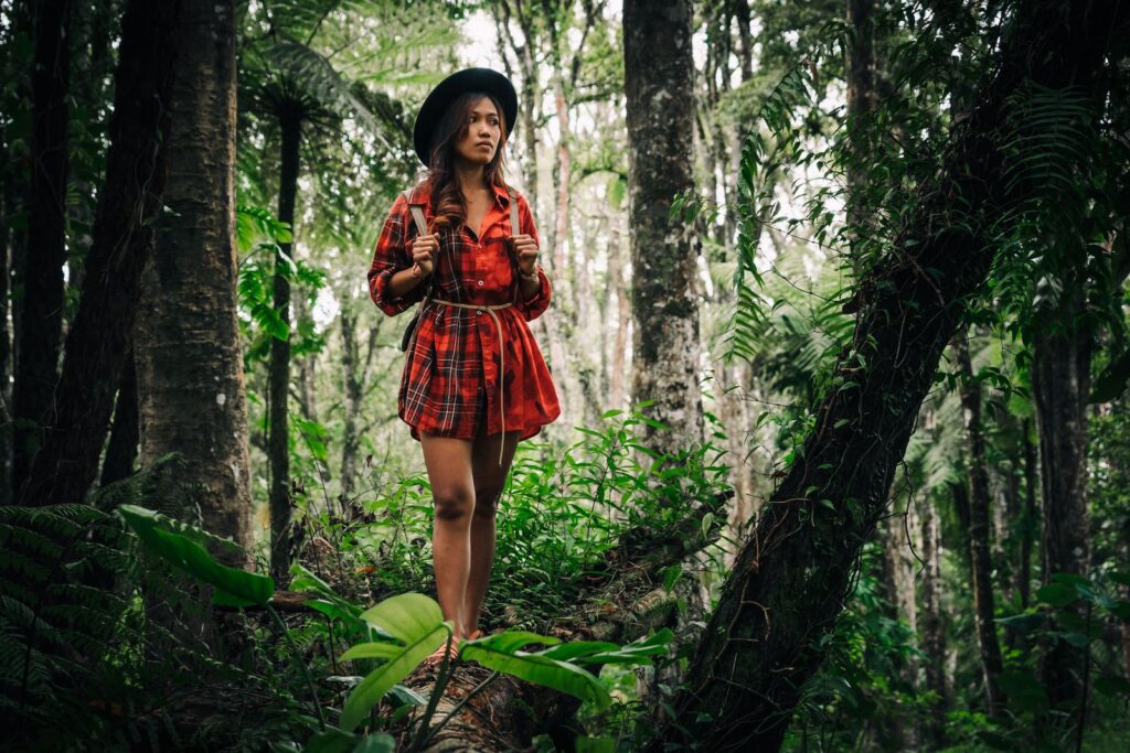 A woman hiking through a green forest