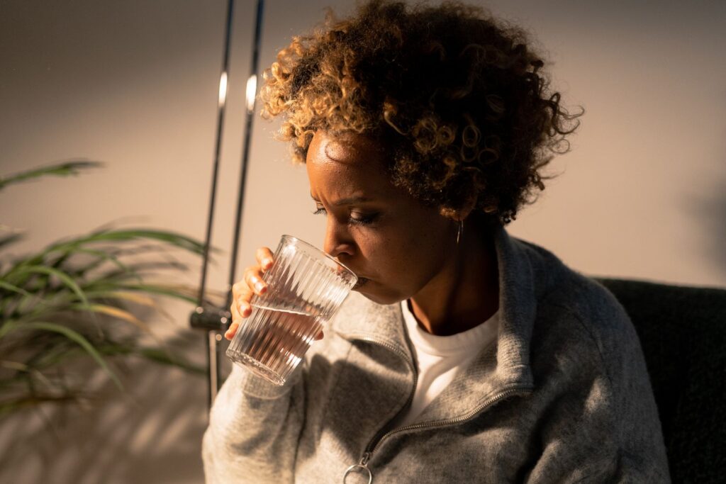 A woman drinking a refreshing glass of water