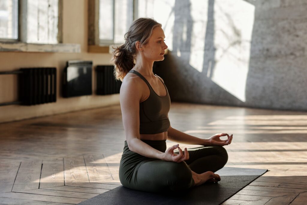 A woman meditating in a calm indoor space