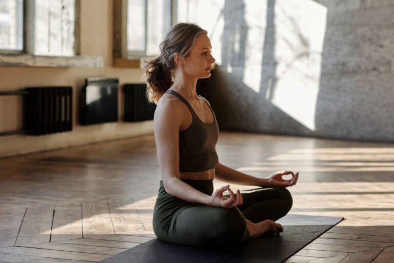 A woman meditating in a calm indoor space