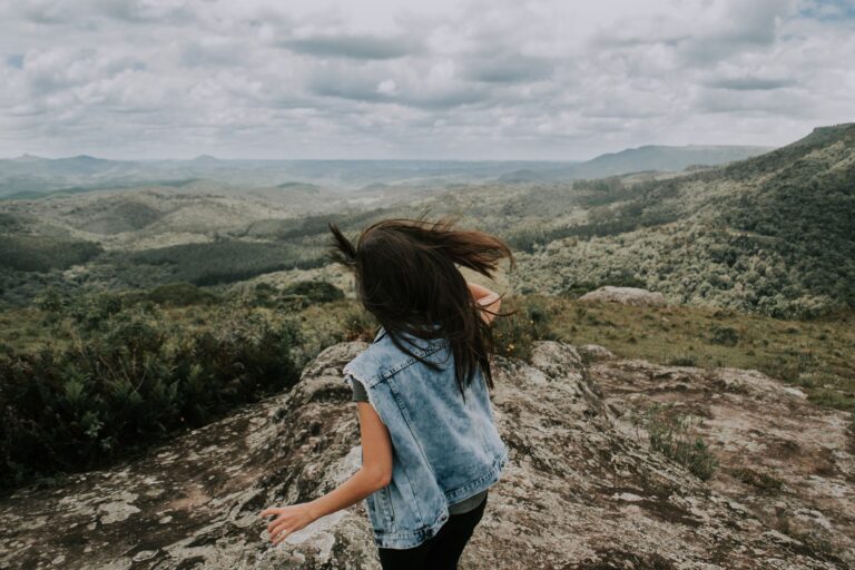 A woman looking out over a mountain landscape