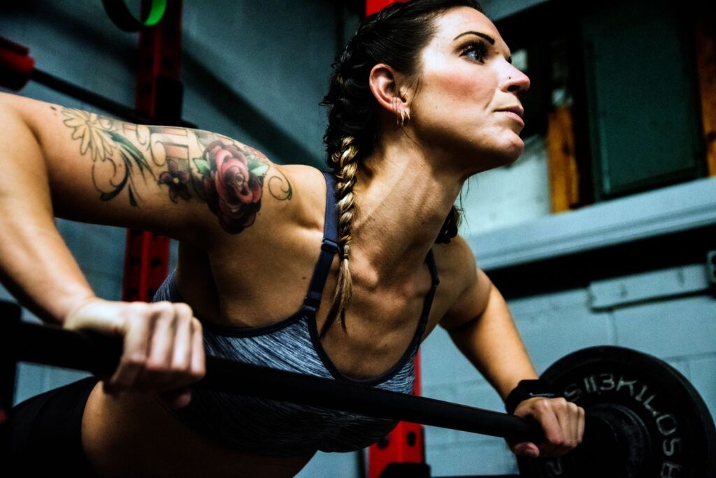 Woman lifting weights with focus during a gym session