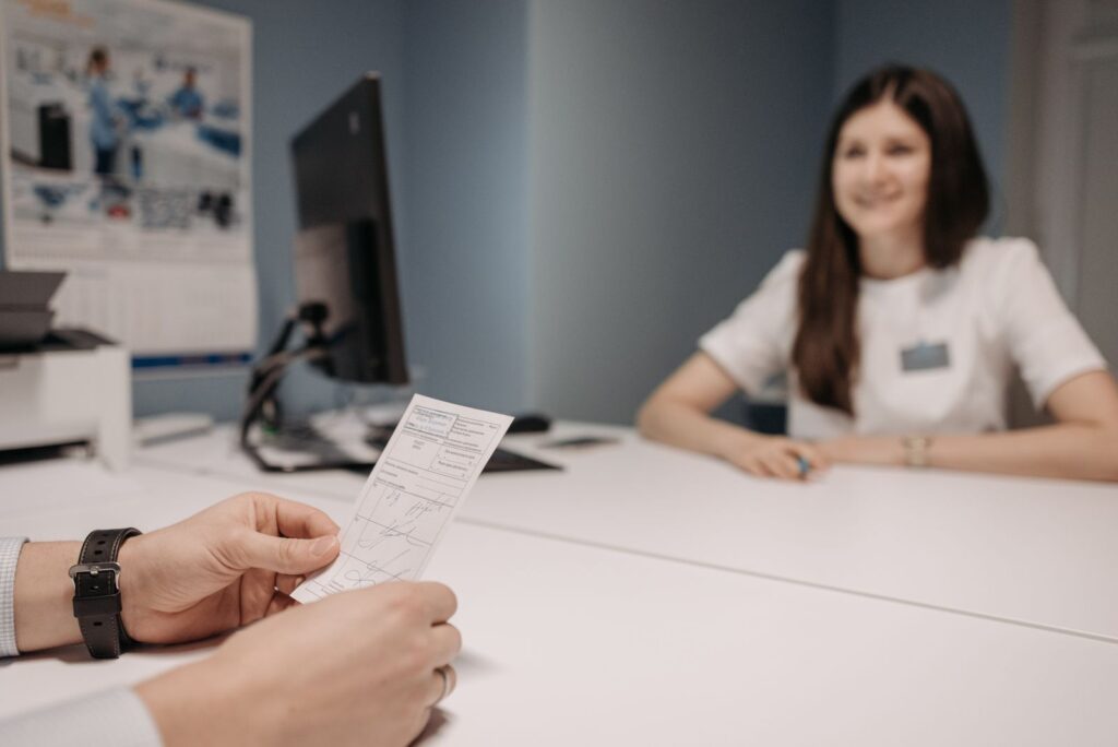 A woman speaking with a healthcare professional at a desk