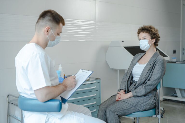 A clinician reviewing notes during a patient consultation