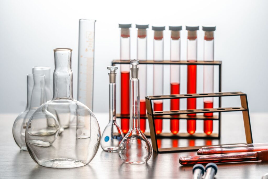 Laboratory glassware and reagent bottles on a bench