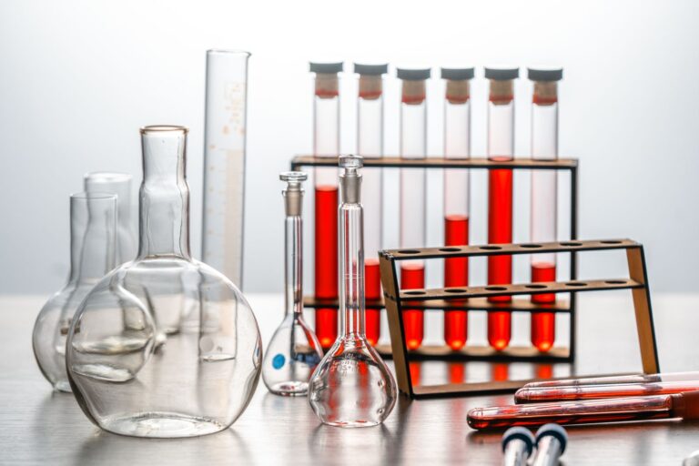 Laboratory glassware and reagent bottles on a bench